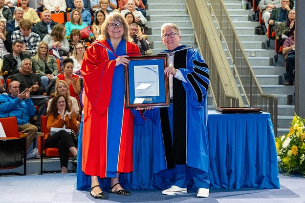 Anna Smol and Joël Dickinson holding the Research Excellence Award at Convocation