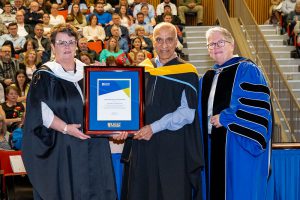 Chandarrao (Kelly) Kale, standing with Dr. Joël Dickinson receiving their award