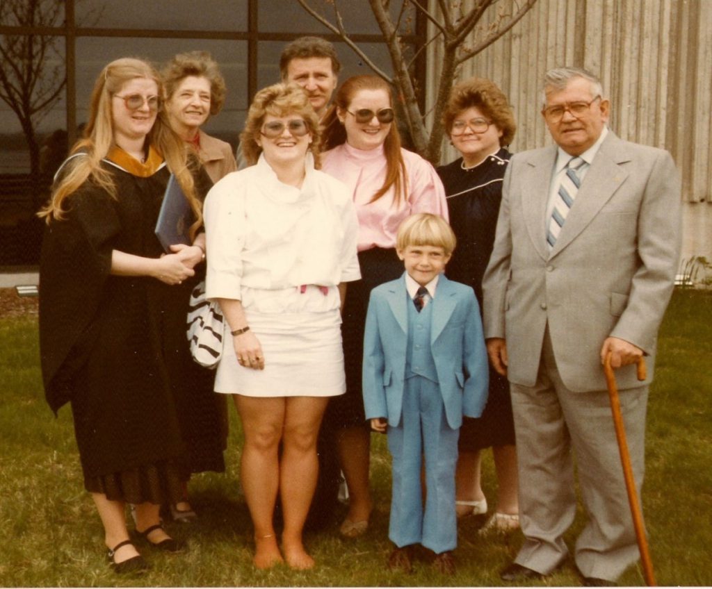 Sue and her family standing outside of Seton at the May 1983 Convocation ceremony