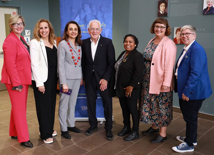 Several attendees standing in front of the Riva Spatz Women's Wall of Honour