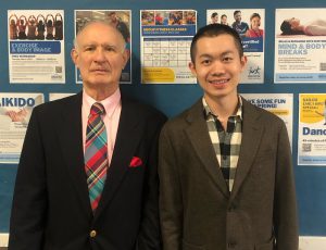 John Carnaghan standing beside a student as they attend convocation