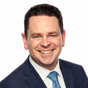 Rob Batherson, smiling for the camera in a business suit