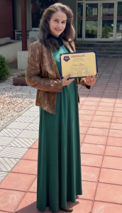 Saira Bano holding her Teaching Certificate.