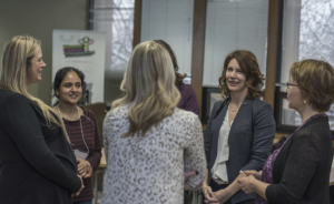 Several attendee speaking in a circle at a WISEatlantic Conference