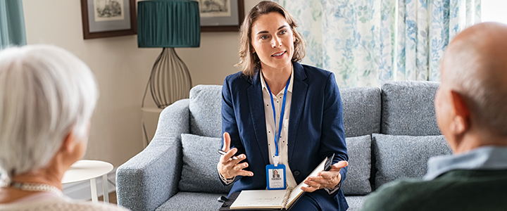 A Case study manager speaking to two people while holding a folder