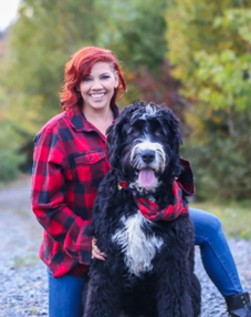 Prof Krista Collier-Jarvis, posing outdoors with her dog.