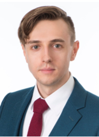 Dr. Matthew Roby - wearing a blue suit with a red tie