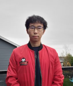 Portrait of tourism co-op student Fei Xie wearing a red jacket