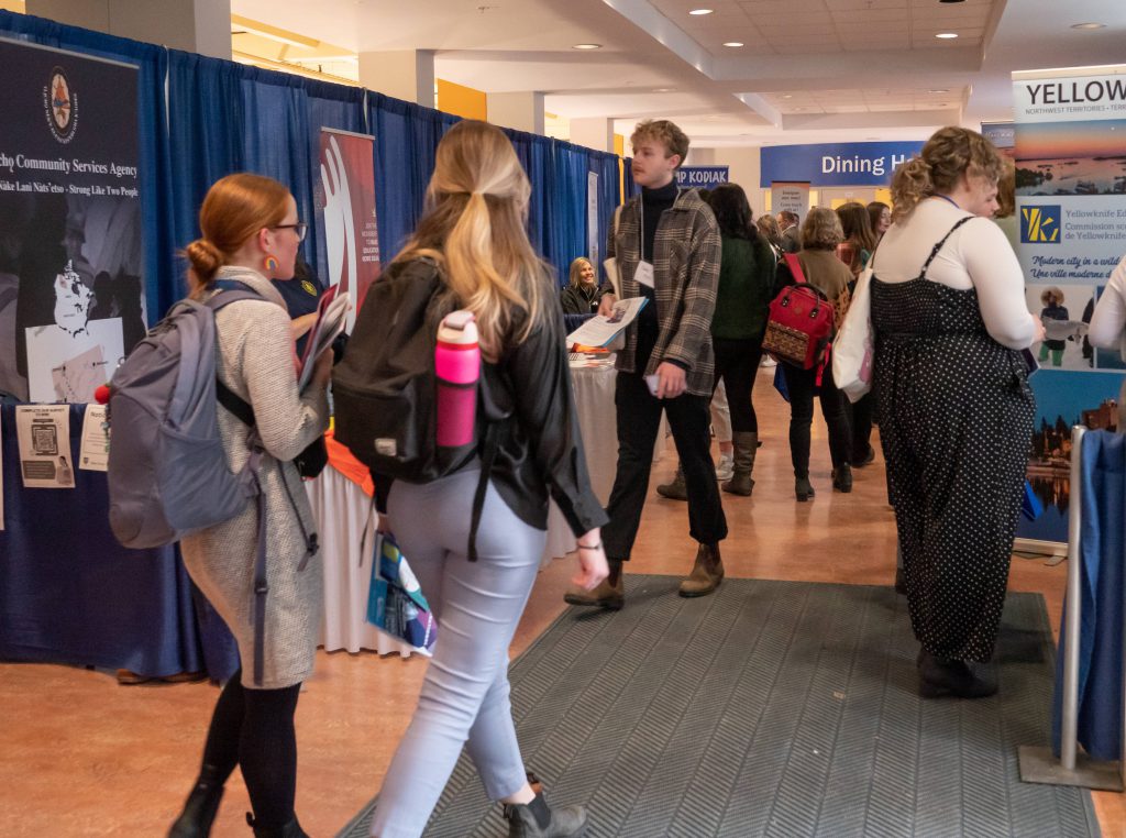 B.Ed. students walk between exhibitor booths at the B.Ed. Job Fair