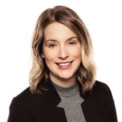 Louisa Dolente, smiling in a headshot on a white background