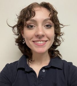 Gabrielle Fenwick, in a black shirt smiling for a selfie