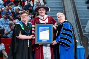 Nick Deal receiving the Alumni Early Career Teaching Award