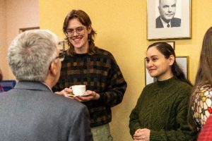 Joshua van Nostrand and Daniela Aguilar speaking to MSVU President Joël Dickinson