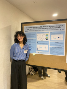 Lily Brigham-Gale in front of her research poster