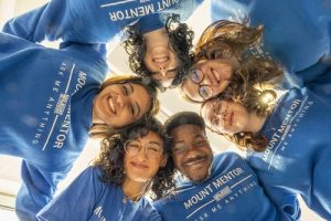 Lily Brigham-Gale in a huddle with other Mount Mentors