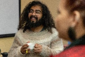 Skyler Anadkat smiling and holding a cup