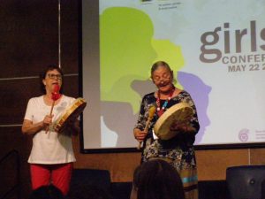 Theresa Meuse, and Flo Blackett, using drums to perform the Indigenous song Strong Woman