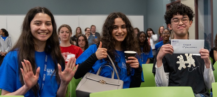 Aulwene Llanes, Lia Afyouni and Mariana Martinez Caloca, smiling and holding the third place prize