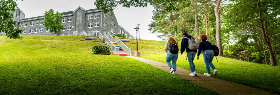 Three students walking towards the Pride Stairs on the MSVU campus