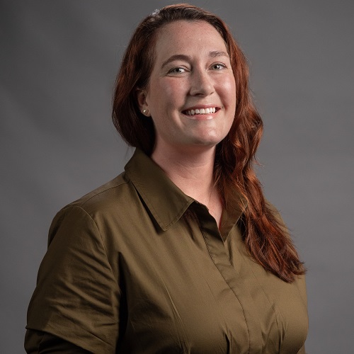 Keely Wallace - the new Executive Director of Advancement at MSVU, wearing a olive shirt, smiling at the camera