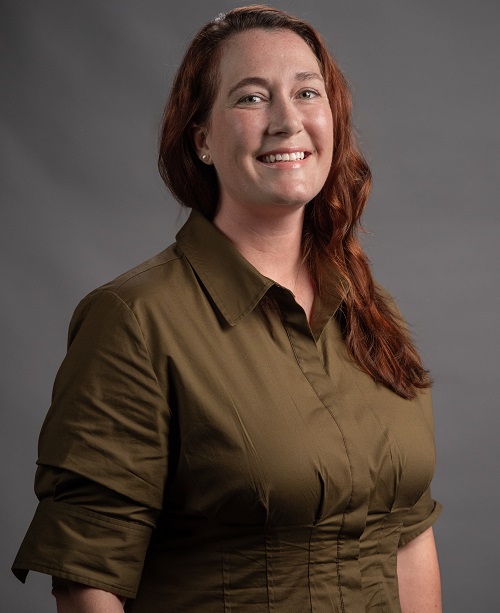 Keely Wallace - the new Executive Director of Advancement at MSVU, wearing a olive shirt, smiling at the camera