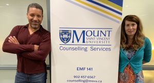 Todd Hunter and Jacqueline Greenough, two of the MSVU Counsellors, standing beside the Counselling Services Banner.