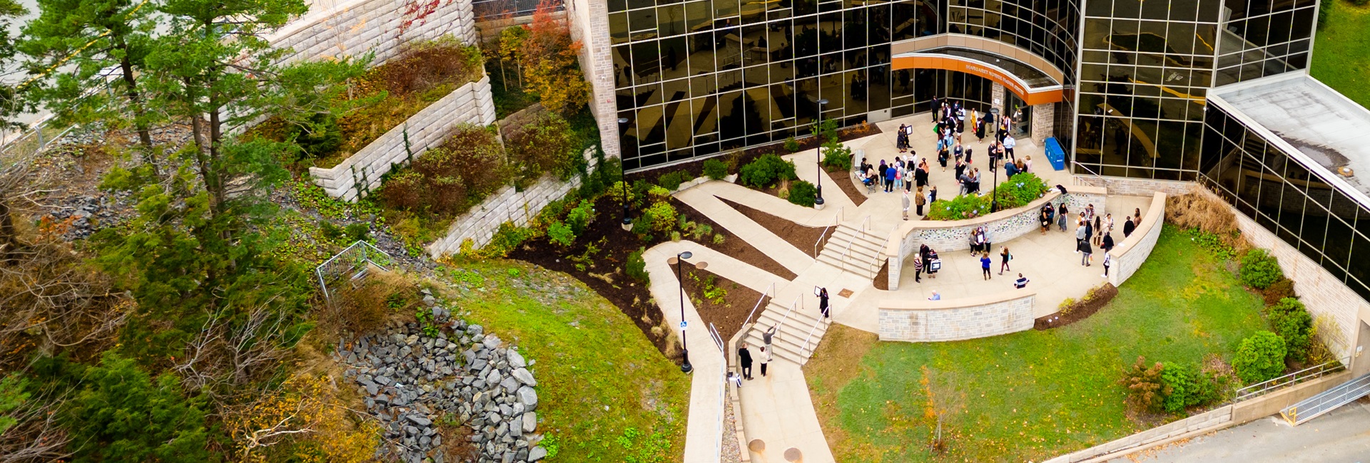 The McCain Building in the Fall weather, with people standing outside the building