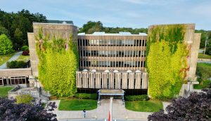 The Seton Academic Centre, looked at overhead through a Drone. There is a student walking towards the building