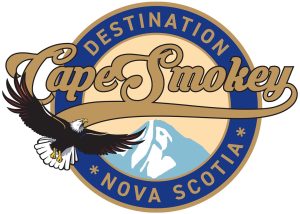 Cape Smokey logo. Has a circle with the words destination Nova Scotia in it with a Mount peak in the middle and an eagle flying on the right hand side. The Cape Smokey logo symbolizes a "mountain by the ocean," representing the unique, raw natural beauty of the Nova Scotia coastline and the resort's elevated, year-round, community-focused lifestyle. It highlights the location as a premier destination for both adventure and natural, scenic exploration on the edge of the continent.