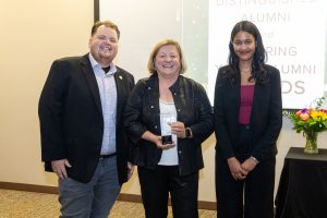 from left, UPEI Alumni Association President Ronnie McPhee, Dr. Janice Keefe holding the Distinguished Alumni Award, UPEI Alumni Association Vice President Leena Daboo