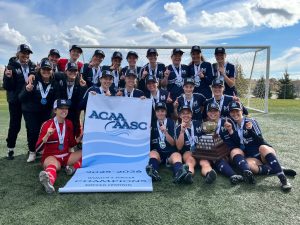 The Mount Saint Vincent University Women's Soccer Team, holding the ACAA Championship pendant and trophy