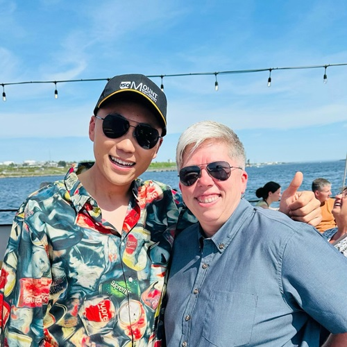 Cong Chen (left) and Joël Dickinson (right), standing outside and smiling at the camera