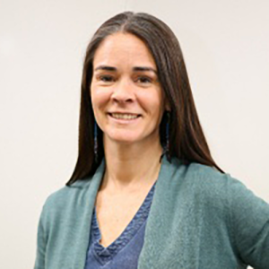 Dr Debbie Martin, wearing a grey-blue cardigan and smiling at the camera