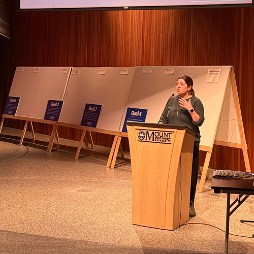 Dr Marisha Caswell speaking at the podium at the Strategic Enrolment Management (SEM) Plan Launch event