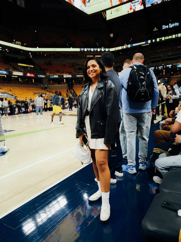 Bailey Williams, standing on the edge of a basketball court