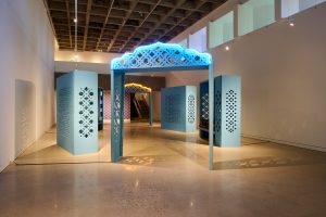 An art gallery with blue arches throughout