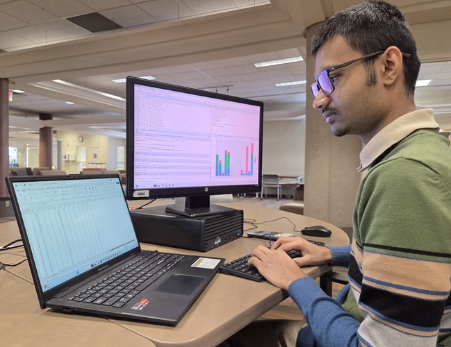 S M Abu Sufian, one of the IBIS Research Project students, working on a laptop in the library