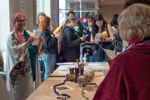 Several participants making crafts as part of the Girls Conference