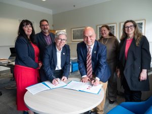 Several MSVU Administrator and Tourism faculty, signing the Memorandum of Understanding with Dr. Ali Arouzi