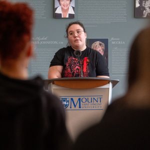 Kayla Bernard with the Indigenous Student Centre speaking at the Red Dress Day event