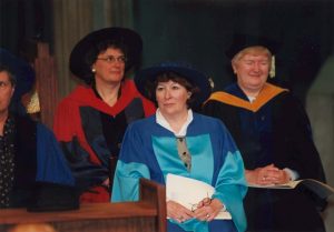 Louise Arbour sitting down as she gets ready to receive her honorary degree, wearing a blue convocation gown
