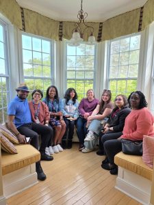 Orinari with several Child and Youth Studies Students sitting in a patio area