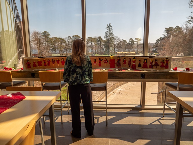 One of the participants looking at the artwork displayed in McCain for the Red Dress Day event