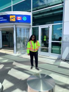 Suwela wearing a safety best outside of the Halifax Stanfield Airport