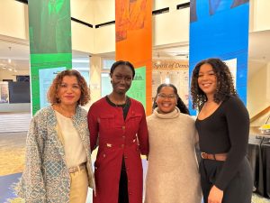 Suwela and 3 other people posing for a photo inside the Black Cultural Centre lobby