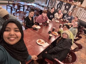 Ummay and several MSVU Students' Union Representatives eating in the Campus Pub