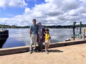Ummay and her family posing in front of a Lake near the docks