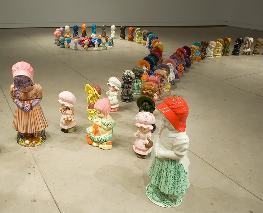 The Brain Child exhibit, featuring ceramic dolls arranged on the floor