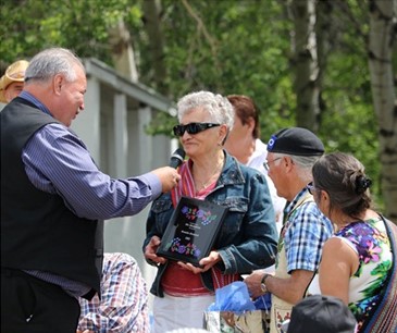 David Chartrand, President of the Manitoba Metis Federation (at left with the mic), speaking to Dr. Kaitlyn Obedzinski Kuryk’s great-aunt Rosalie Dreilich