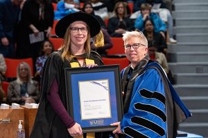 Danielle Cox, receiving the Presidents Award for Research Excellence from Dr. Joël Dickinson at the Fall 2026 Convocation Ceremony.